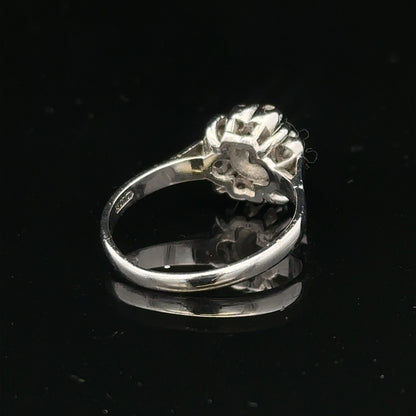9ct white gold cluster diamond ring by Reeves and Sons featuring a sparkling diamond cluster design.