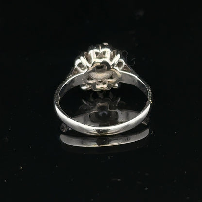 9ct white gold cluster diamond ring by Reeves and Sons featuring a sparkling diamond design and intricate metalwork.