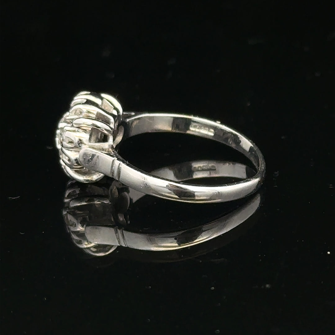 9ct white gold cluster diamond ring by Reeves and Sons featuring sparkling diamonds arranged in a elegant design.