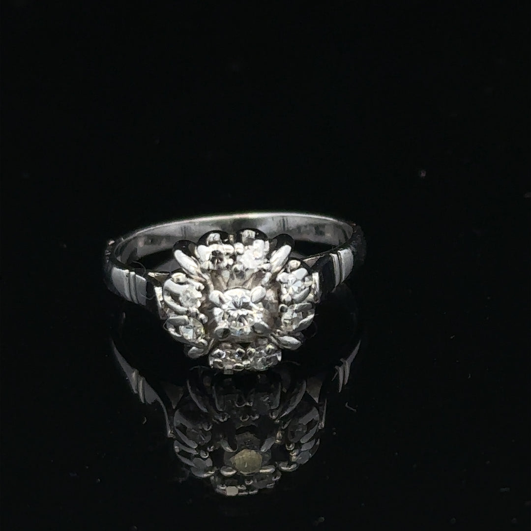 9ct white gold cluster diamond ring by Reeves and Sons featuring sparkling diamonds in a elegant design.