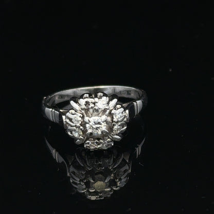 9ct white gold cluster diamond ring by Reeves and Sons featuring sparkling diamonds in a elegant design.