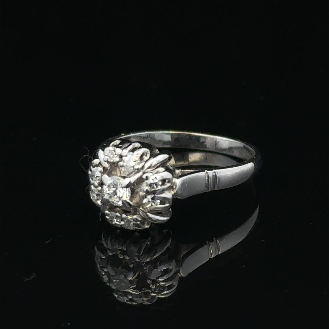 9ct white gold cluster diamond ring by Reeves and Sons, featuring sparkling diamonds set in a elegant design.