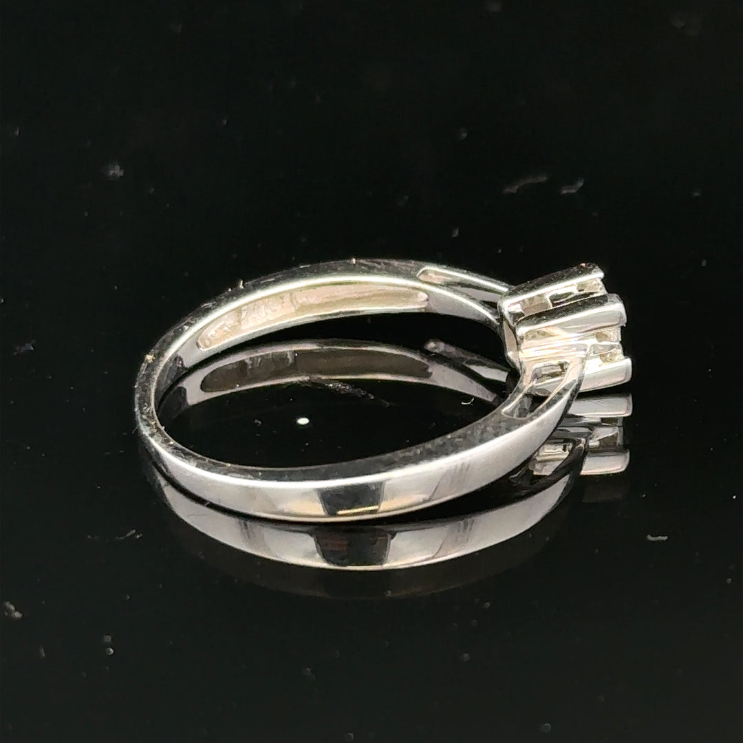 9ct white gold diamond ring with sparkling stones, showcasing elegant craftsmanship and a sleek, polished finish.