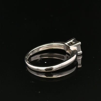 18ct white gold diamond ring with a central diamond, size J1/2, showcasing elegant jewelry craftsmanship.