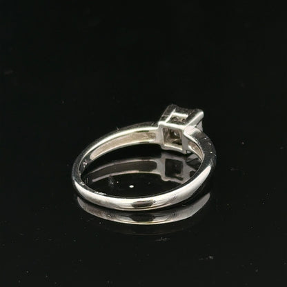 18ct white gold diamond ring with a central diamond, size J1/2, featuring elegant craftsmanship and sparkling gemstone details.