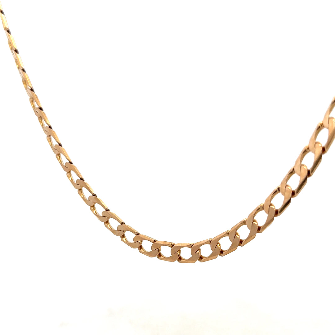 9ct yellow gold curb chain weighing 27.6g from Reeves and Sons, close-up of the chain's links and shiny gold finish