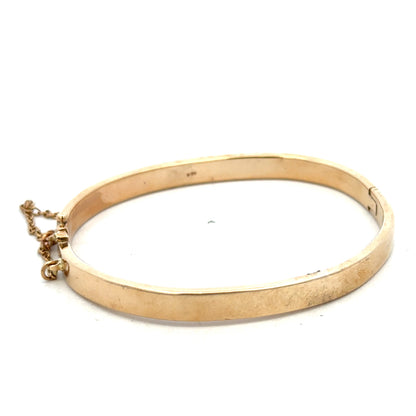 9ct yellow gold bangle weighing 24.1g, featuring a smooth, polished finish and classic design from Reeves and Sons.