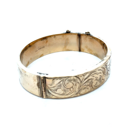 9ct yellow gold bangle with a smooth finish, weighing 22.7g, from Reeves and Sons, displayed on a white background.