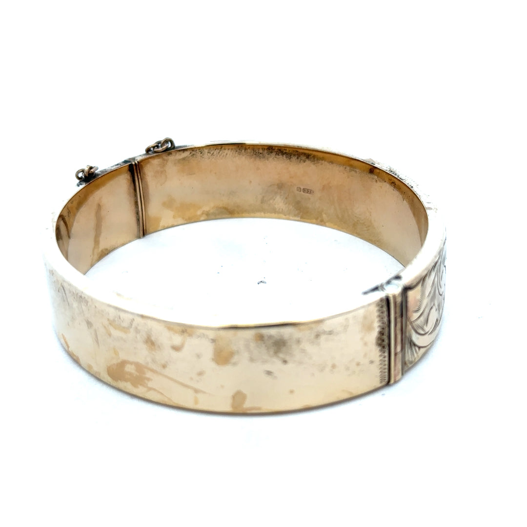 9ct yellow gold bangle with a smooth, polished finish, weighing 22.7g, from Reeves and Sons.