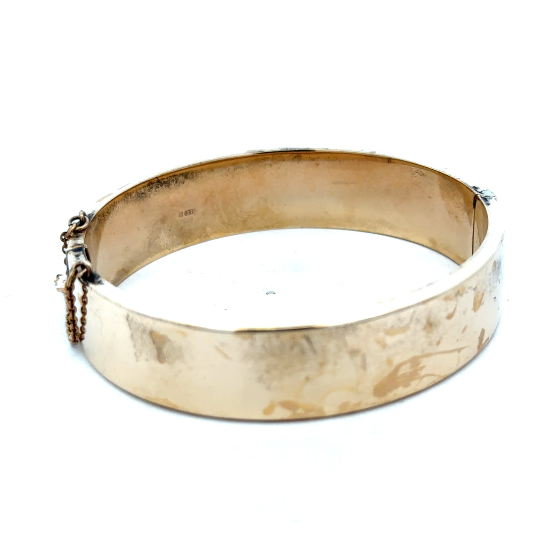 9ct yellow gold bangle weighing 22.7g, featuring a smooth polished surface and classic design, crafted by Reeves and Sons.