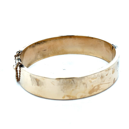 9ct yellow gold bangle weighing 22.7g, featuring a smooth polished surface and classic design, crafted by Reeves and Sons.
