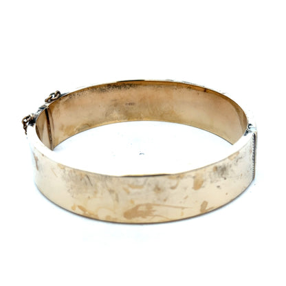 9ct yellow gold bangle with a smooth polished finish, weighs 22.7g, from Reeves and Sons.