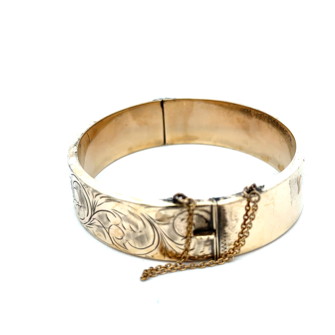 9ct yellow gold bangle weighing 22.7g from Reeves and Sons, showcasing a smooth, polished jewelry design.