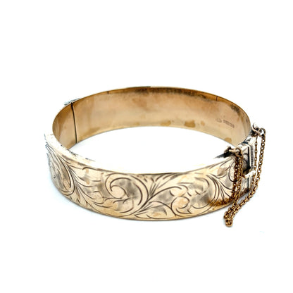 9ct yellow gold bangle with a smooth finish, weighing 22.7g, by Reeves and Sons, displayed on a neutral background.