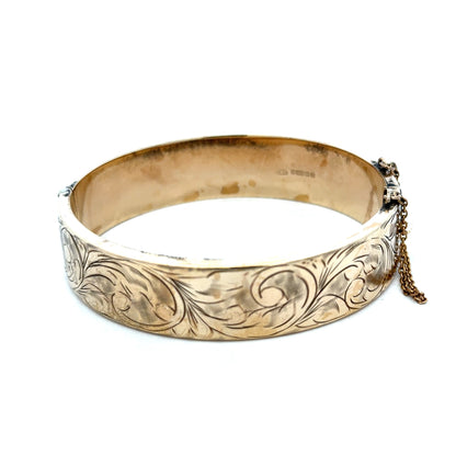 9ct yellow gold bangle weighing 22.7g, featuring a sleek and polished design, from Reeves and Sons.