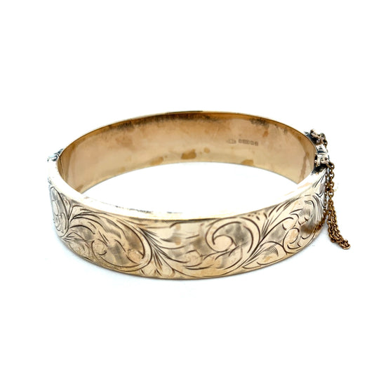 9ct yellow gold bangle weighing 22.7g, featuring a sleek and polished design, from Reeves and Sons.
