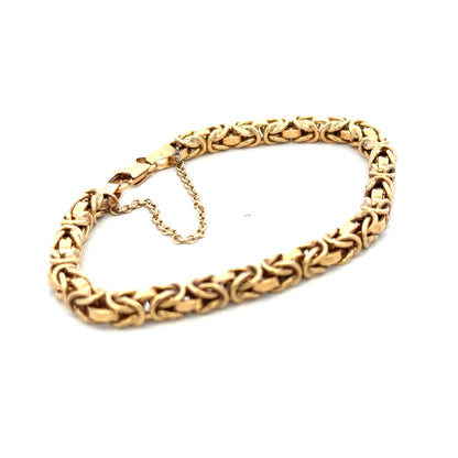 9ct yellow gold bracelet weighing 10.8g, featuring a delicate chain design, from Reeves and Sons.