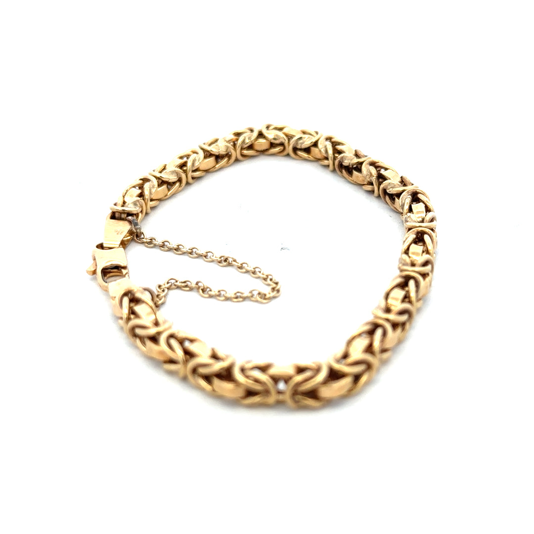 9ct yellow gold bracelet weighing 10.8g with intricate link design from Reeves and Sons, displayed on a neutral background.