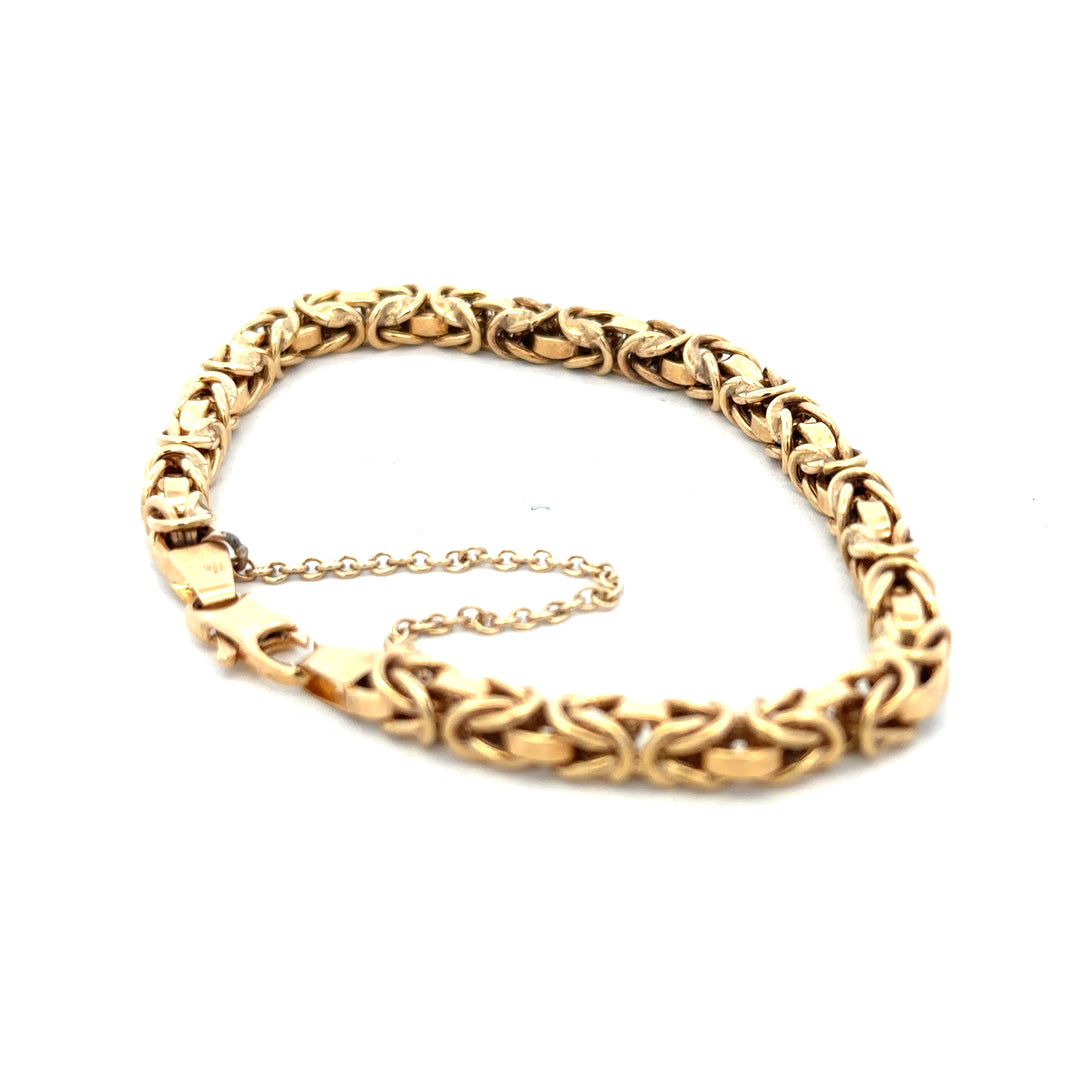 9ct yellow gold bracelet weighing 10.8g with intricate link design, crafted by Reeves and Sons.