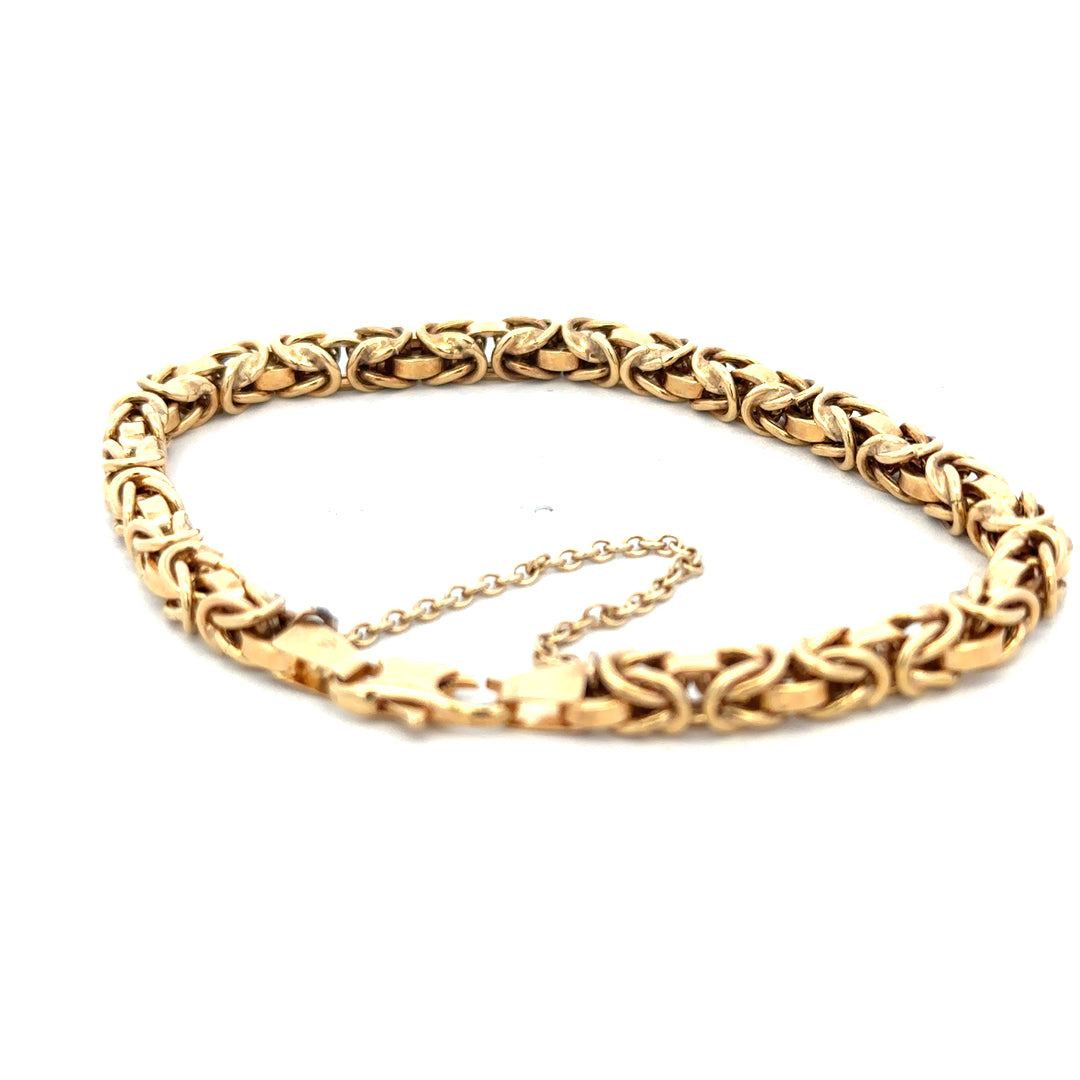 9ct yellow gold bracelet weighing 10.8g with intricate link design, crafted by Reeves and Sons.