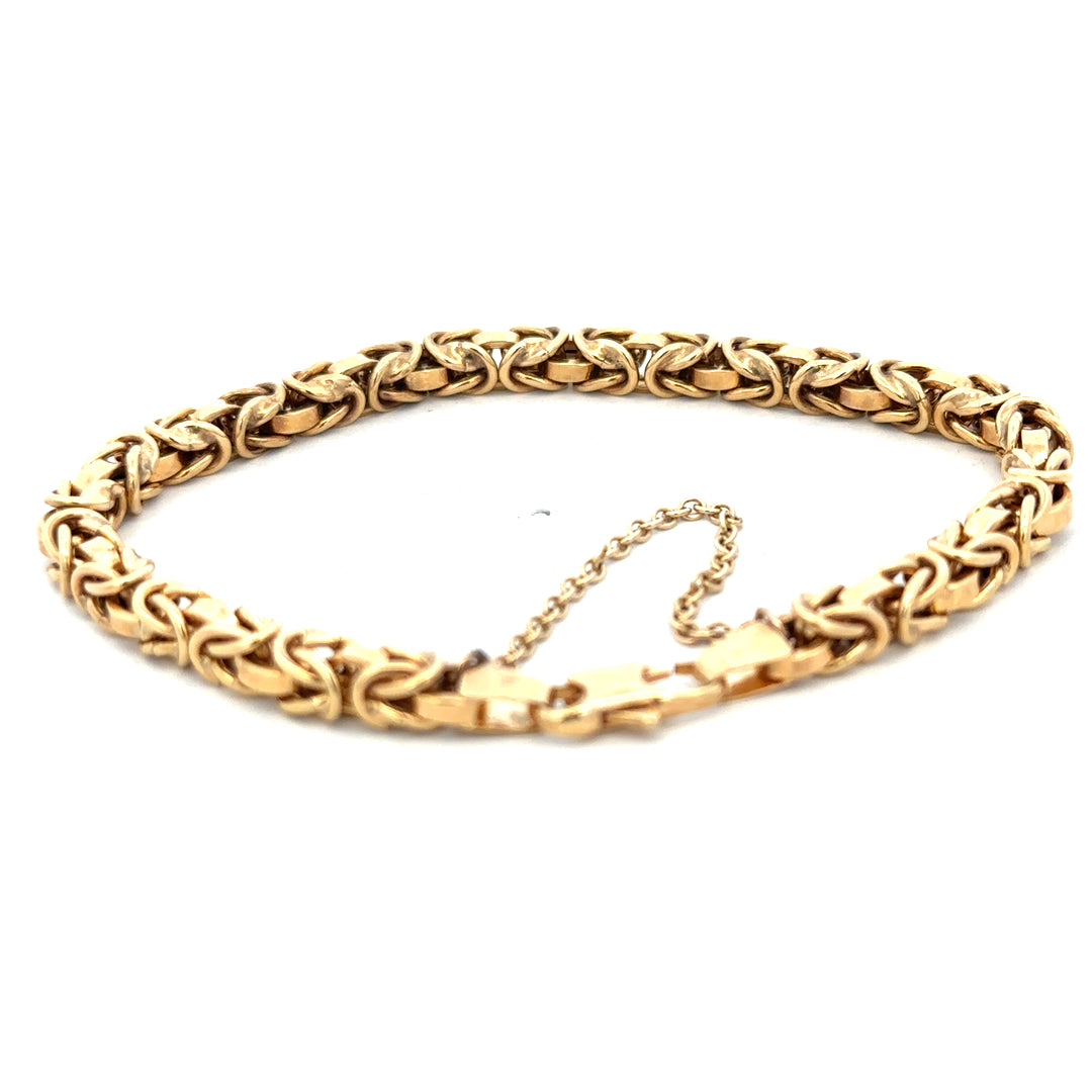 9ct yellow gold bracelet weighing 10.8g with intricate link design, crafted by Reeves and Sons, shown in close-up.
