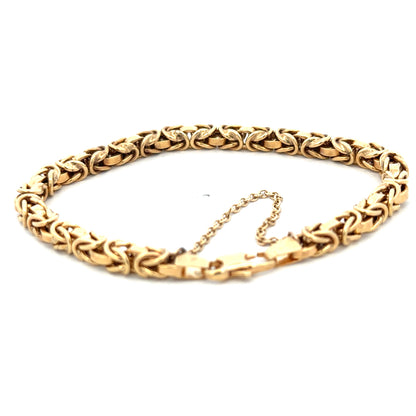 9ct yellow gold bracelet weighing 10.8g with intricate link design, crafted by Reeves and Sons, shown in close-up.