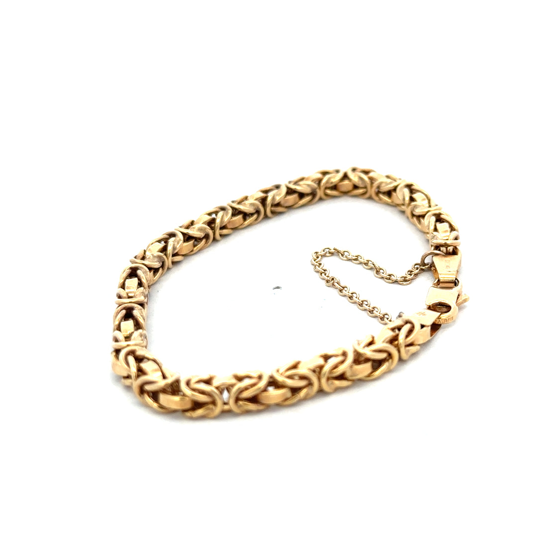 9ct yellow gold bracelet weighing 10.8g with intricate link design, crafted by Reeves and Sons.