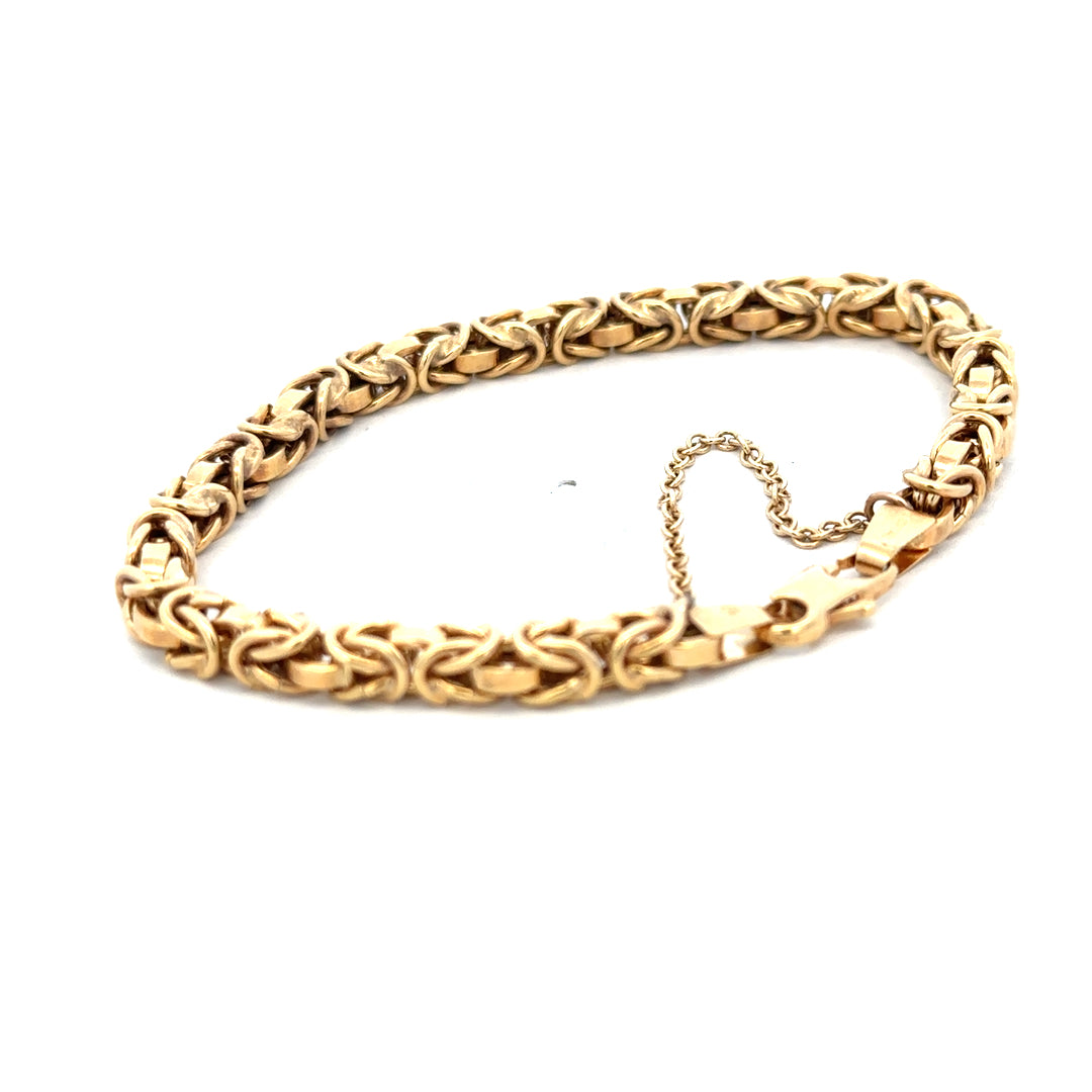 9ct yellow gold bracelet weighing 10.8g with intricate link design, crafted by Reeves and Sons.