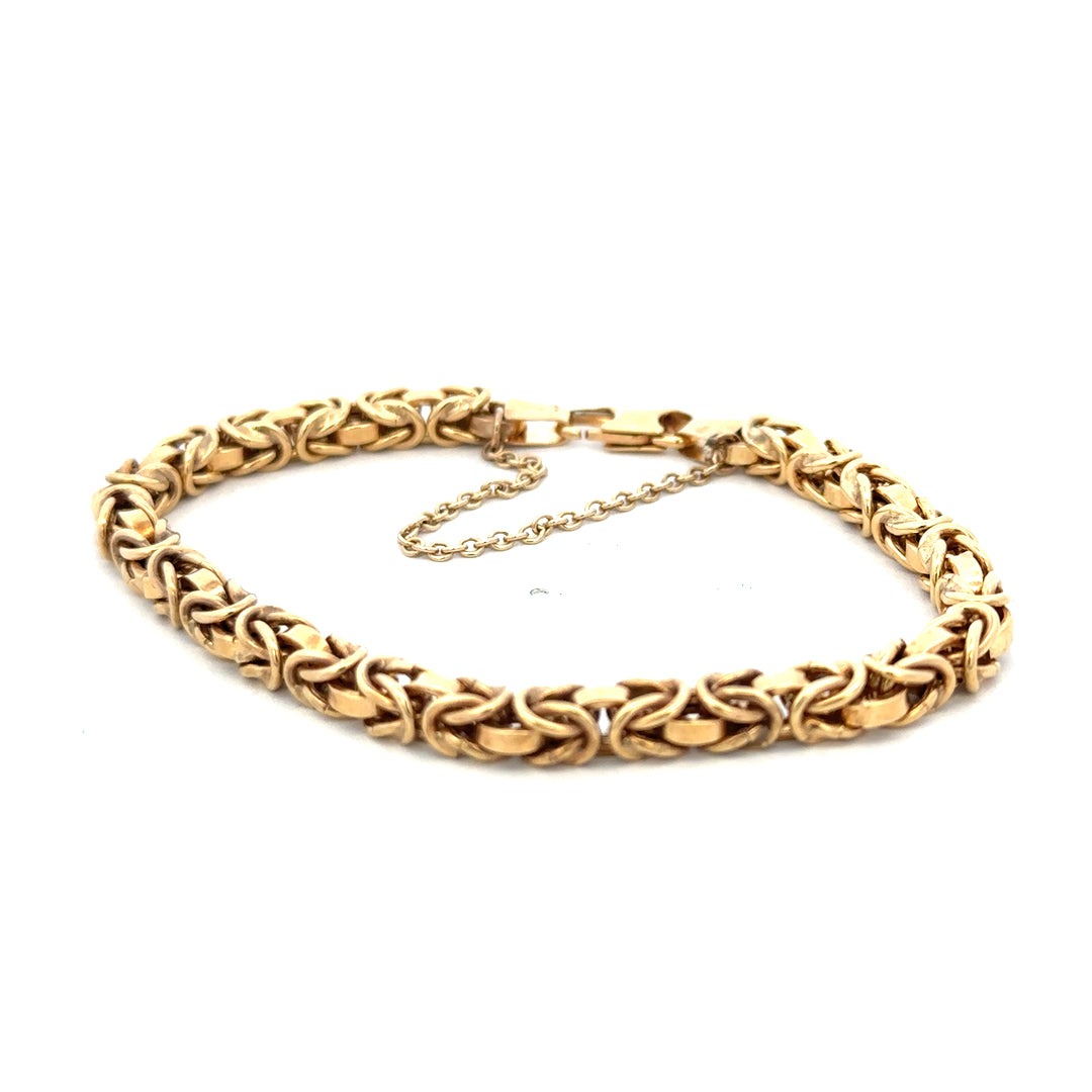 9ct yellow gold bracelet weighing 10.8g with intricate design, displayed on a neutral background, by Reeves and Sons.
