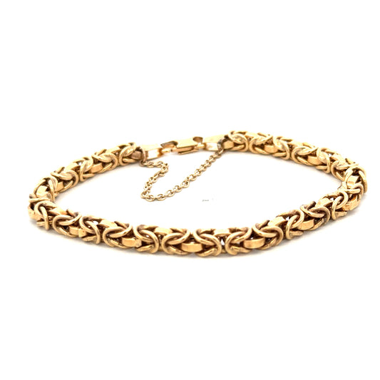 9ct yellow gold bracelet weighing 10.8g, featuring a delicate chain design, by Reeves and Sons, displayed on a neutral background.