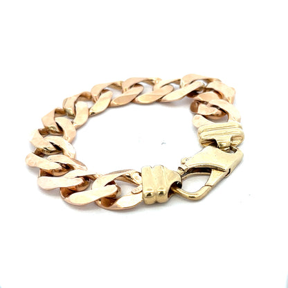 9ct yellow gold curb bracelet weighing 63.6g, showcasing a shiny, linked chain design from Reeves and Sons.