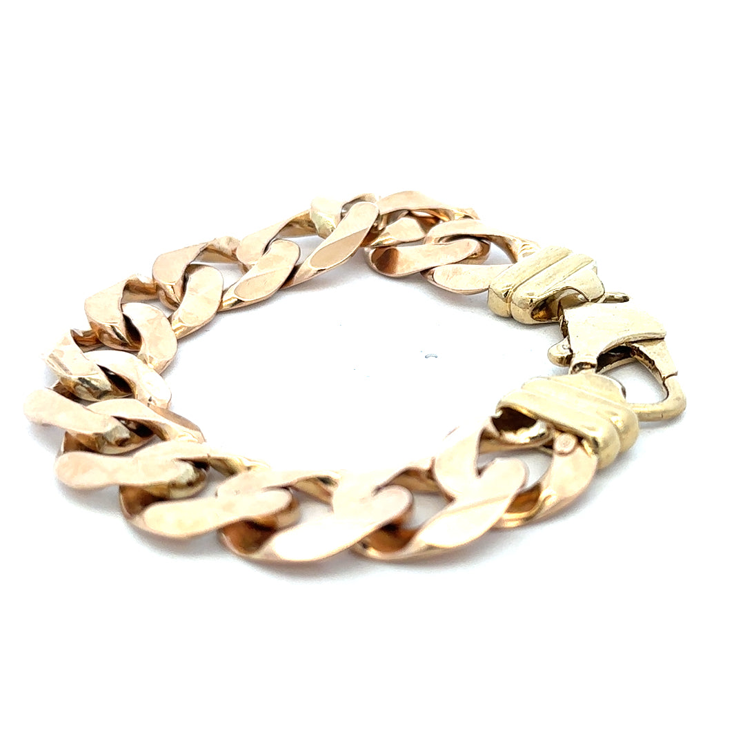 9ct yellow gold curb bracelet weighing 63.6g, showcasing its sleek links and polished finish, from Reeves and Sons.