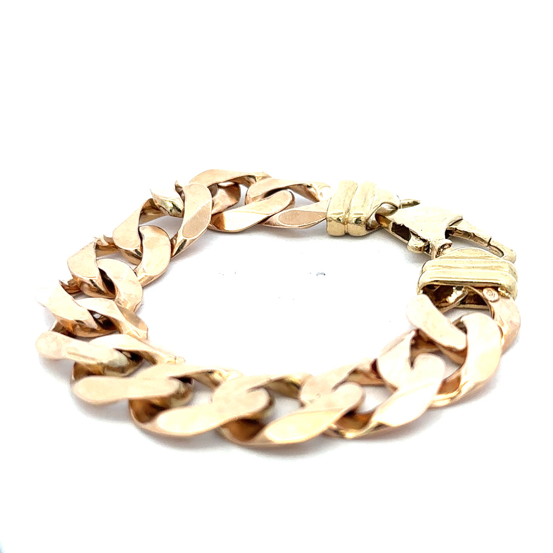 9ct yellow gold curb bracelet weighing 63.6g, featuring a classic chain design, crafted by Reeves and Sons.