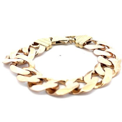 9ct yellow gold curb bracelet weighing 63.6g, featuring a classic linked design, displayed on a neutral background.