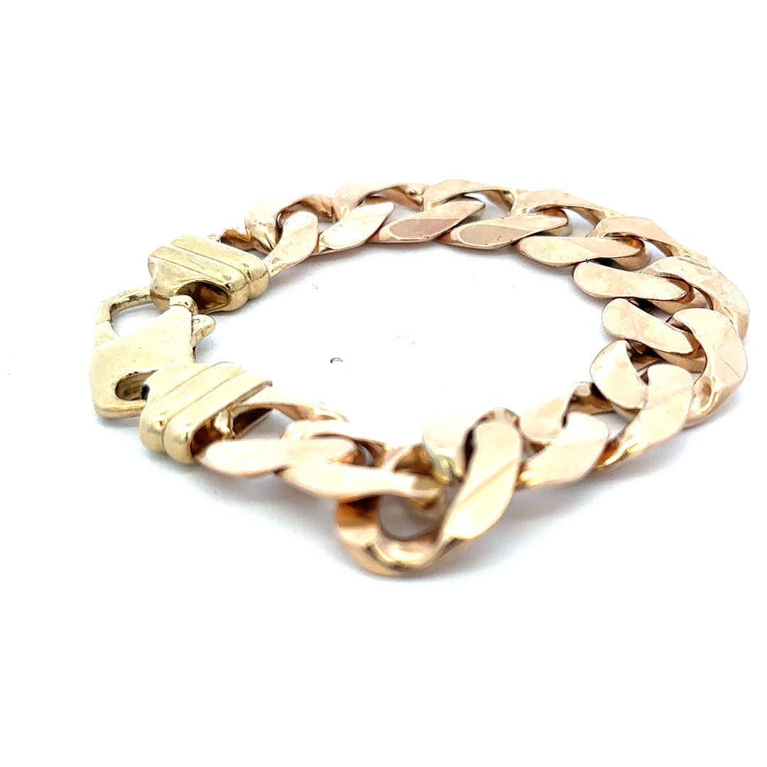 9ct yellow gold curb bracelet weighing 63.6g with a polished finish, crafted by Reeves and Sons.