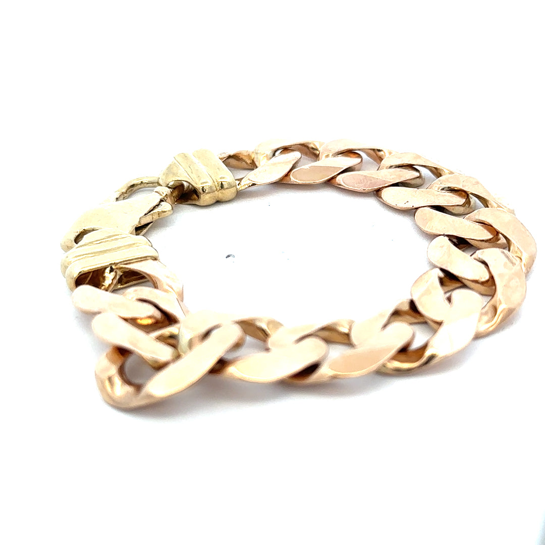 9ct yellow gold curb bracelet weighing 63.6g, showcasing a sleek and polished design with Reeves and Sons craftsmanship.
