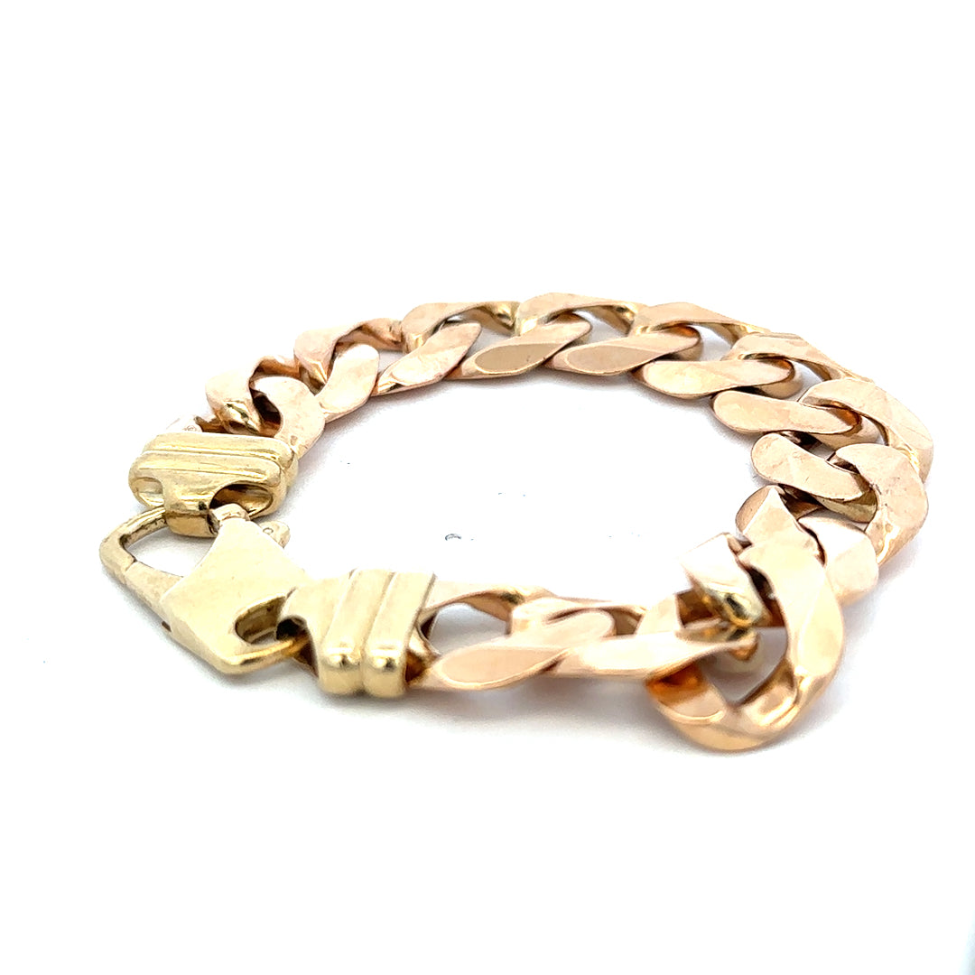 9ct yellow gold curb bracelet weighing 63.6g with Reeves and Sons branding, featuring a polished, linked chain design.