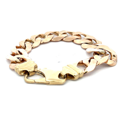 9ct yellow gold curb bracelet weighing 63.6g with a polished finish, featuring linked oval-shaped gold chains.