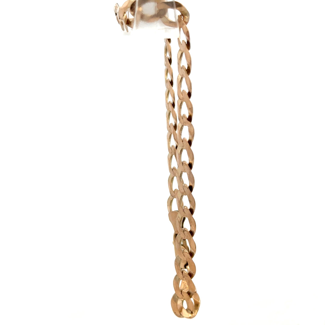 9ct yellow gold curb bracelet weighing 7.7g, featuring interlocking links, crafted by Reeves and Sons, shown in close-up.
