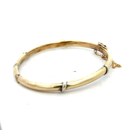 9ct yellow gold bangle weighing 11.1g, featuring a smooth, polished finish and elegant design from Reeves and Sons.