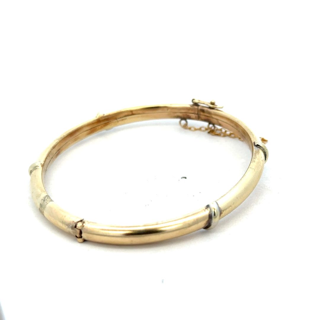 9ct yellow gold bangle from Reeves and Sons, weighing 11.1g, with a smooth, polished surface and classic round shape.