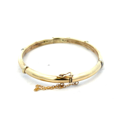 Elegant 9ct yellow gold bangle weighing 11.1g, featuring a smooth, polished finish, from Reeves and Sons.