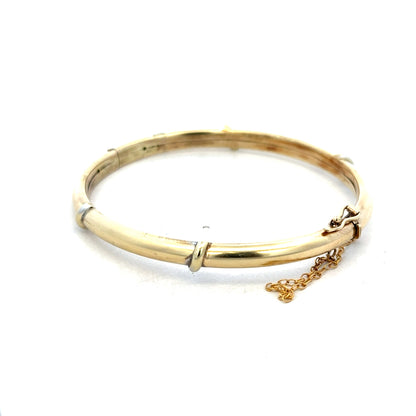 9ct yellow gold bangle with a smooth polished finish, weight 11.1g, from Reeves and Sons.