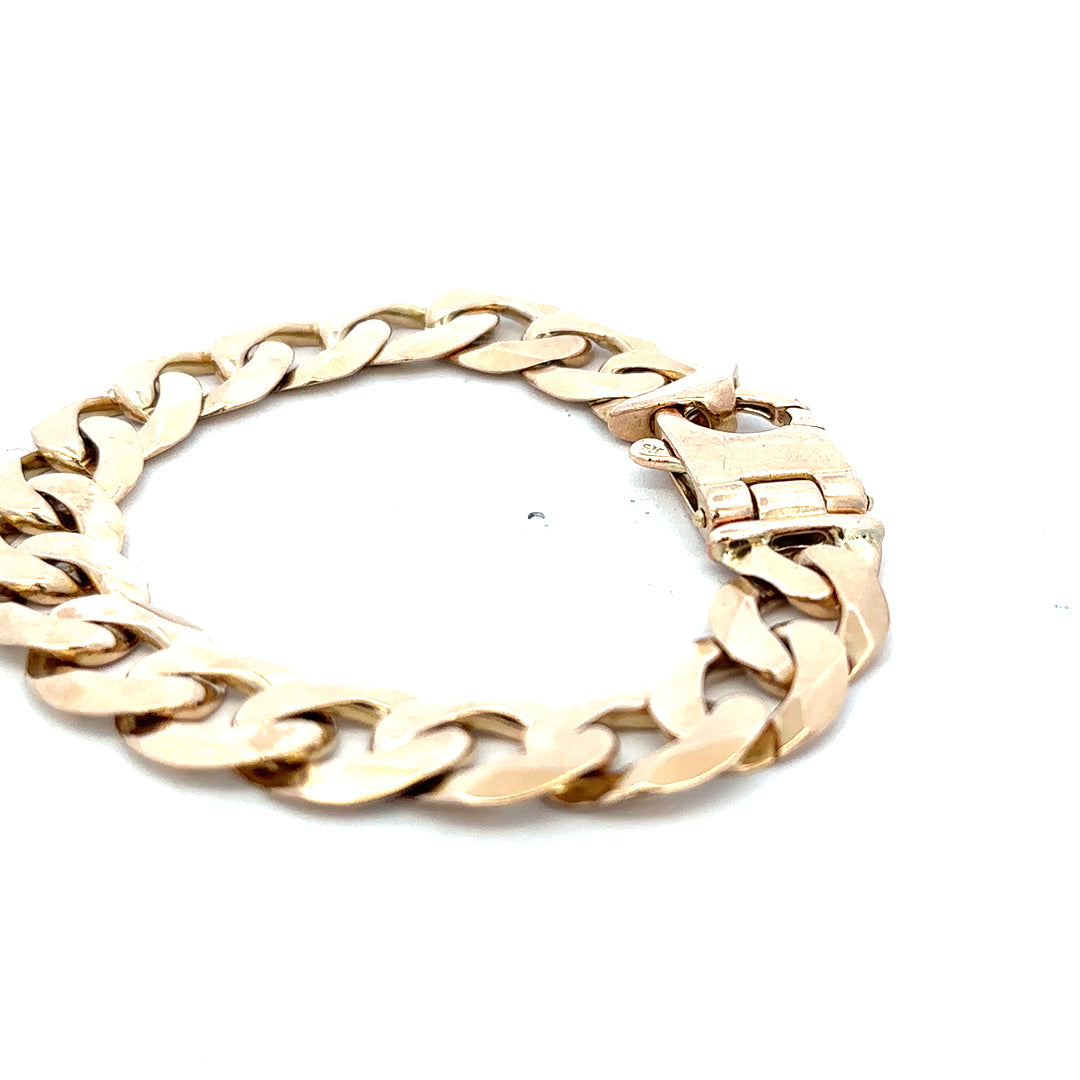 9ct yellow gold curb bracelet weighing 48.1g with a polished finish, featuring a classic chain design, by Reeves and Sons.