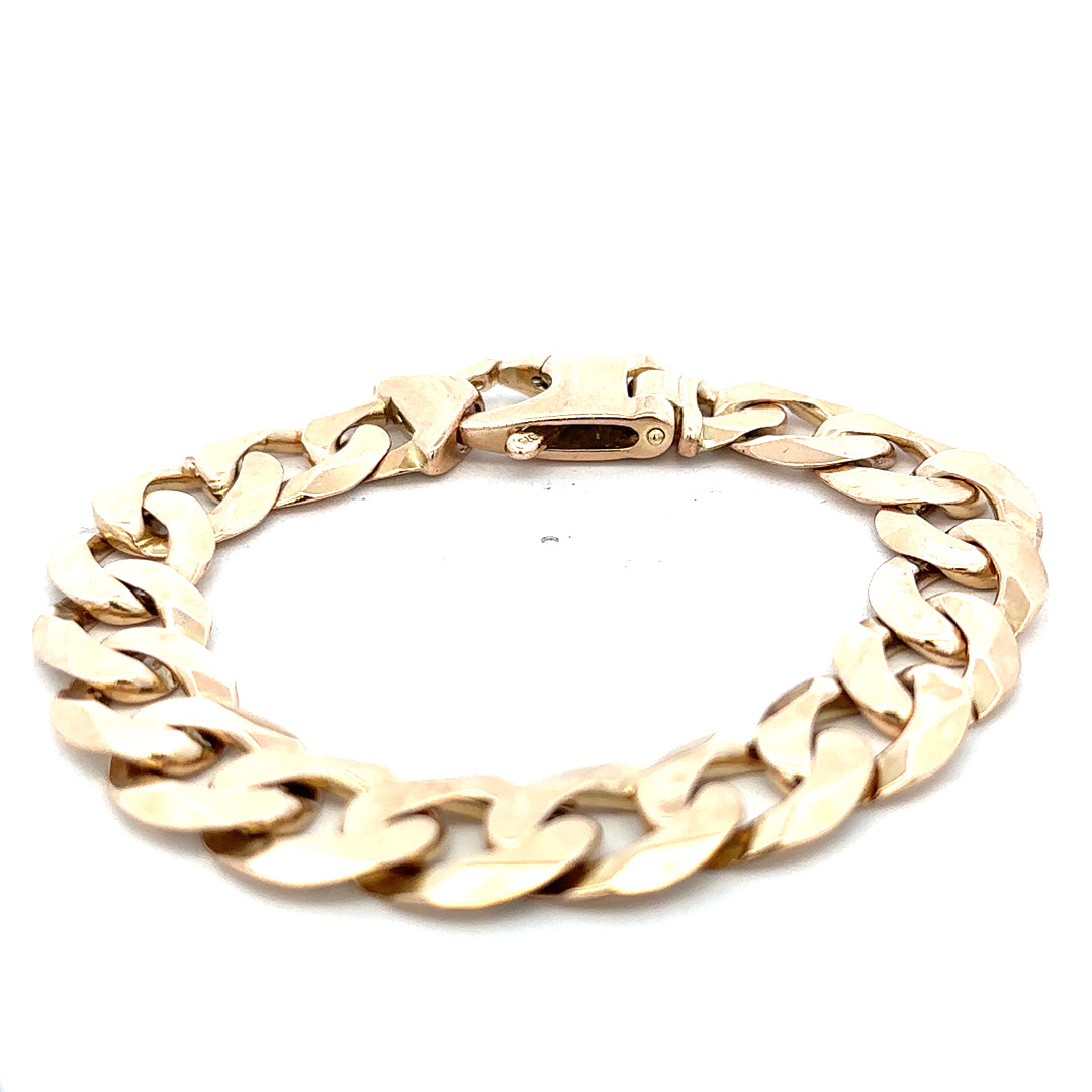 9ct yellow gold curb bracelet weighing 48.1g with a polished finish, featuring classic linked design by Reeves and Sons.