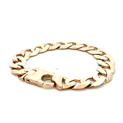 9ct yellow gold curb bracelet weighing 48.1g with Reeves and Sons branding, displayed on a neutral background.