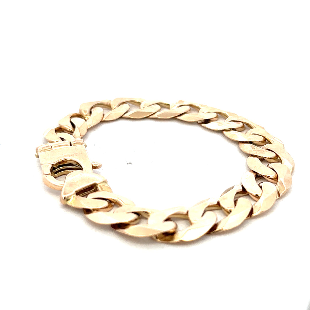 9ct yellow gold curb bracelet weighing 48.1g with a sturdy chain design, crafted by Reeves and Sons.