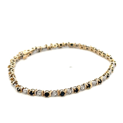 9ct yellow gold sapphire and diamond bracelet with intricate design, weighing 4.8g, crafted by Reeves and Sons.