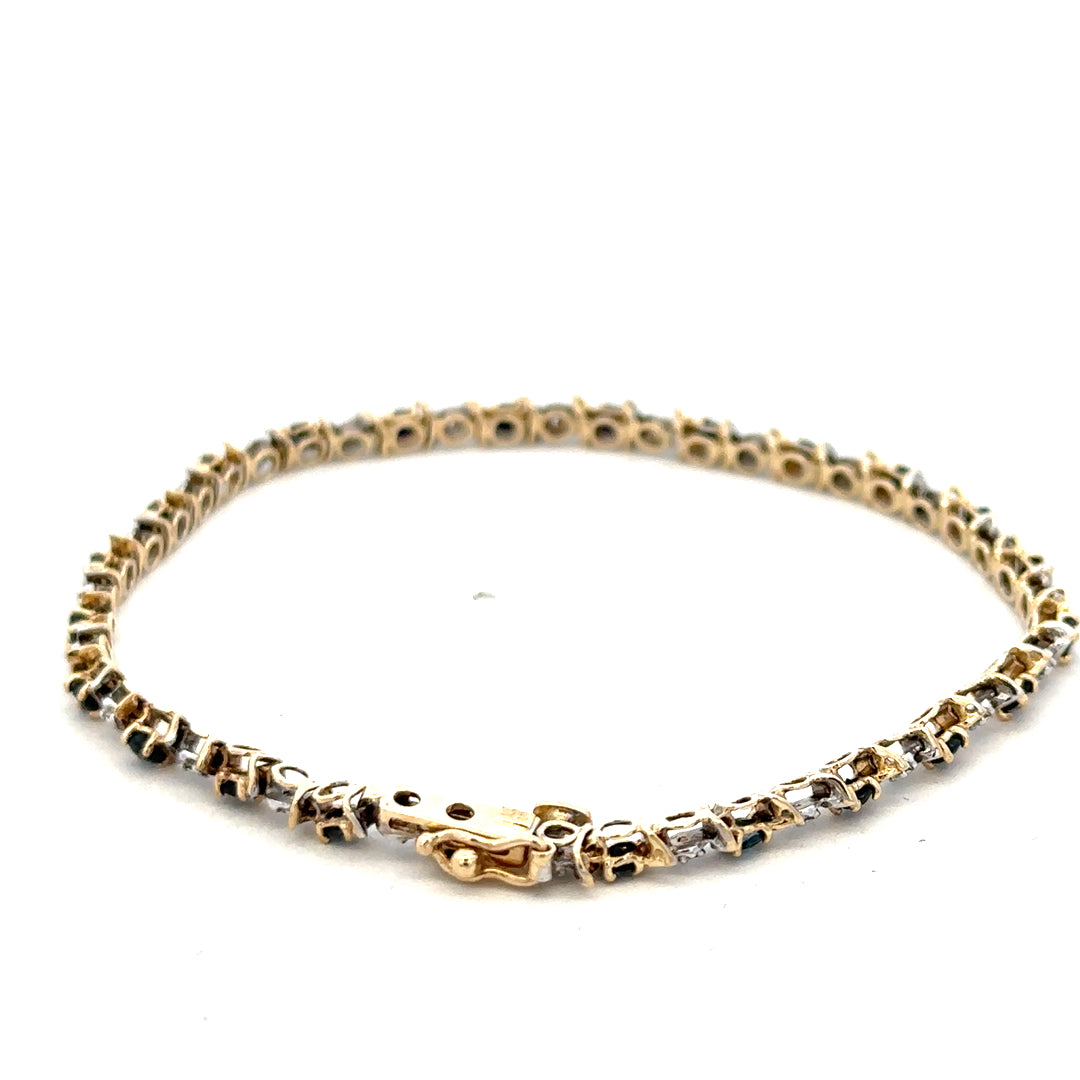 9ct yellow gold sapphire and diamond bracelet by Reeves and Sons, featuring a delicate design with sparkling gemstones.