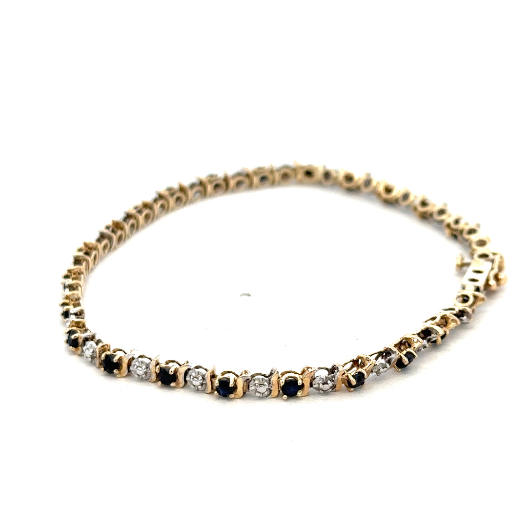9ct yellow gold sapphire and diamond bracelet with intricate design, weighing 4.8g, crafted by Reeves and Sons.